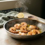 Seasoned shrimp searing in a hot steel skillet for shrimp pita, edges just turning opaque pink