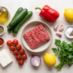 Keto Mediterranean ground beef skillet ingredients arranged raw on a stone counter
