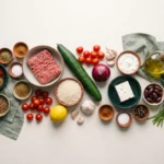 Raw ingredients for Greek ground beef gyro bowl arranged on a counter