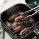 Air fryer beef kofta kebabs browning in the basket