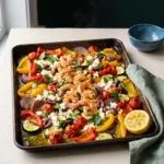 Sheet pan Mediterranean shrimp and vegetables on one roasting tray with feta, olives and parsley