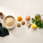 Raw ingredients laid out: brown basmati rice, ground turmeric, cumin, coriander, onion, garlic, lemon, parsley and olive oil