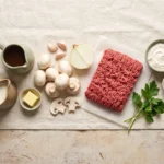 Raw ingredients for keto ground beef stroganoff: mince, white mushrooms, butter, broth, cream, sour cream