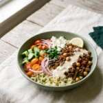 Mediterranean ground beef meal prep bowls: spiced beef, chickpeas, lemon bulgur, cucumber salad and tahini in a bowl