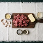 Raw sirloin, butter, tallow, and garlic for carnivore garlic butter steak bites