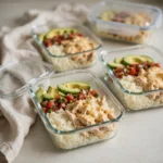 Chicken burrito bowl under 500 calories packed into glass meal-prep containers for the week