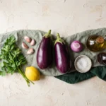 Raw ingredients for Greek eggplant dip arranged overhead